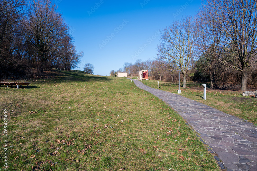 Stone path in meadow with trees nearby. Autumn. Stone path in meadow with trees nearby. Autumn.