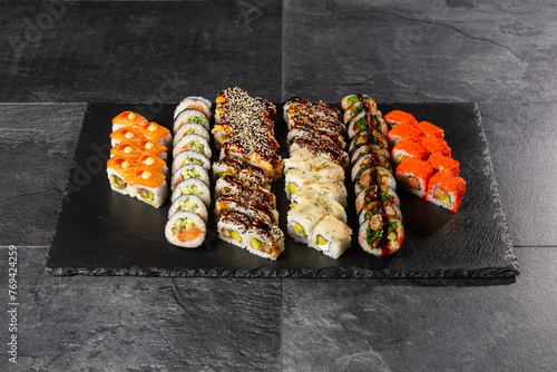 Large size sushi menu for party on dark stone background