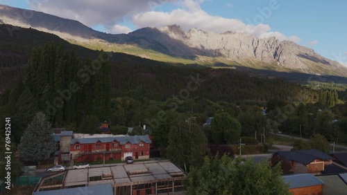 Accommodations And Forest At The Foot Of Piltriquitron Mountain In El Bolson, Argentina. ascending drone shot photo