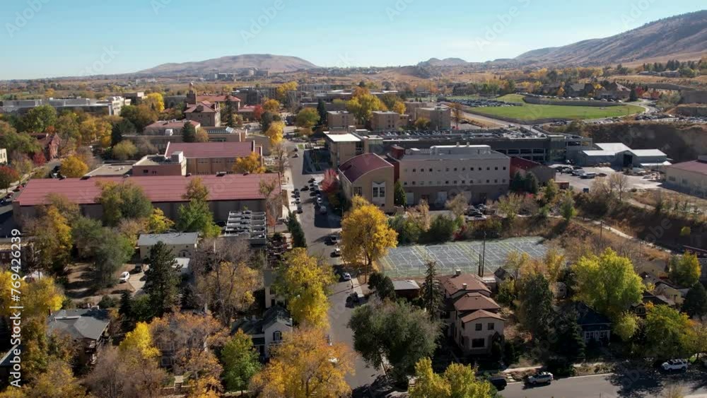 A 4K drone shot over the pristine, tranquil town of Golden, Colorado, and the Colorado School of Mines college campus, just outside the Rocky Mountain foothills, during the colorful Fall season. A 4K drone shot over the pristine, tranquil town of Golden, Colorado, and the Colorado School of Mines college campus, just outside the Rocky Mountain foothills, during the colorful Fall season.