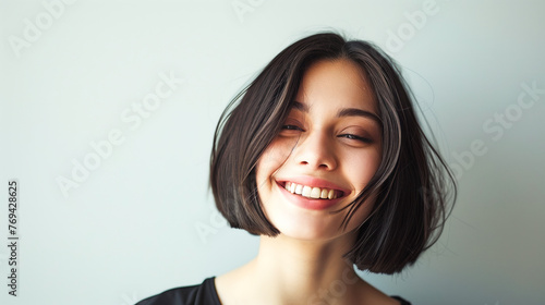 Young woman with blunt bob short hairstyle on white background © Graphicgrow