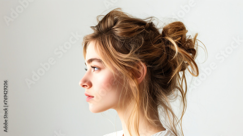 Young woman with messy textured bun hairstyle
