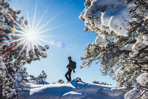 Woman hikes through winter wonderland at Acadia National Park photo