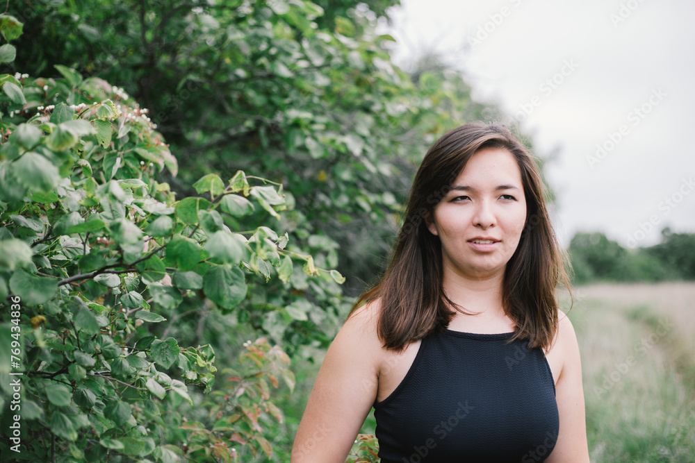 Young half-Korean woman enjoying nature on cloudy summer day Young half-Korean woman enjoying nature on cloudy summer day