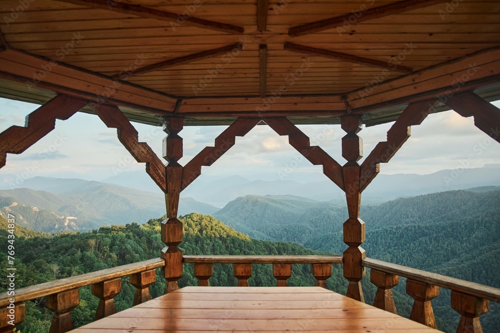 Wooden gazebo in a mountainous area. To explore the natural landscape. Tourism and travel