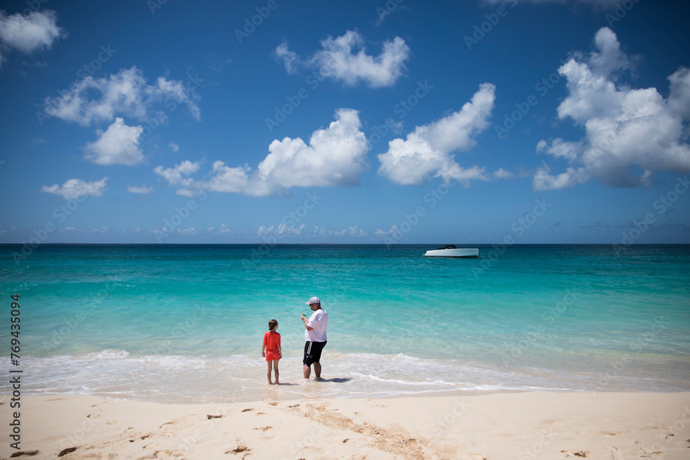 Rear View Wide Angle of Man and Daughter Standing on Caribbean Beach Rear View Wide Angle of Man and Daughter Standing on Caribbean Beach