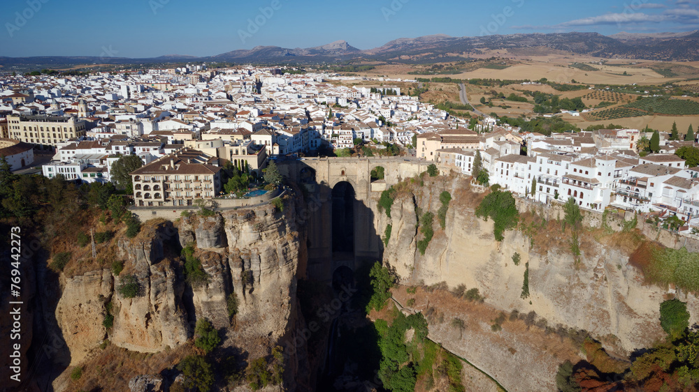Aerial drone view of The Puente Nuevo, New Bridge in Ronda. White villages in the province of Malaga, Andalusia, Spain. Beautiful village on the cliff of the mountain. Touristic destination. Holidays.