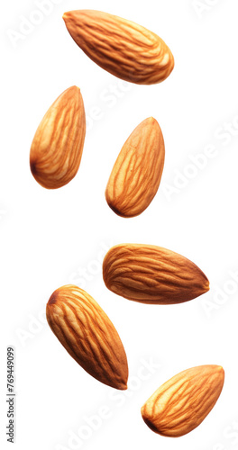 Tasty almonds falling on white background