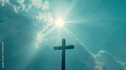 Cross, clear silhouette on the background of light clouds, rays of the sun illuminate it from behind, power of faith, light bright background, wallpaper