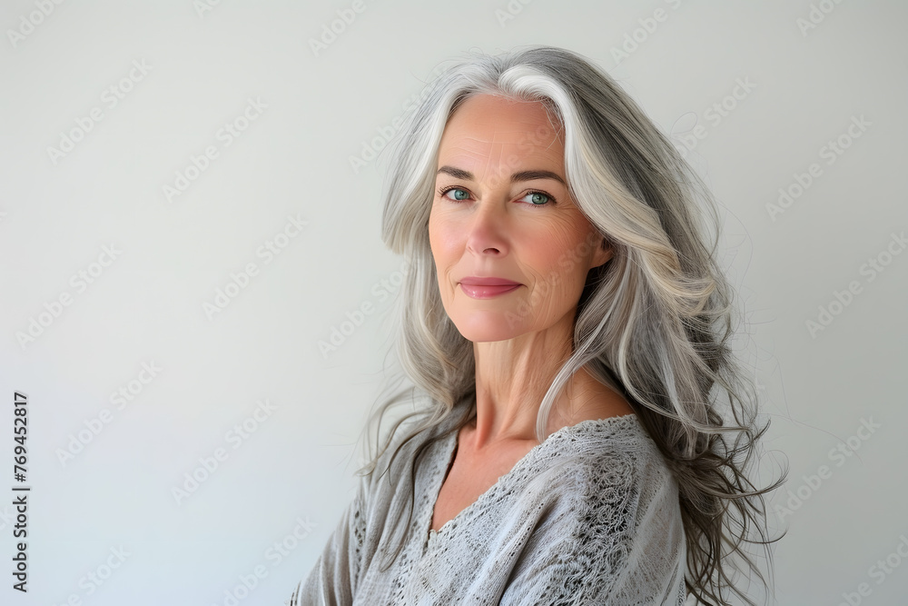 Fototapeta premium Closeup portrait of Beautiful mature woman, 50+ years, looking at the camera, white background