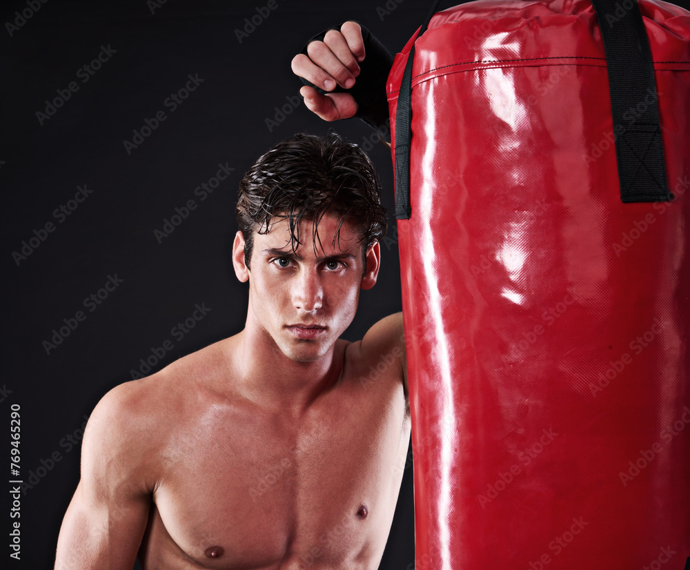 Fitness, mma and portrait of man with punching bag in studio for exercise, challenge or competition training. Power, muscle or champion boxer at workout with confidence, fight and black background Fitness, mma and portrait of man with punching bag in studio for exercise, challenge or competition training. Power, muscle or champion boxer at workout with confidence, fight and black background