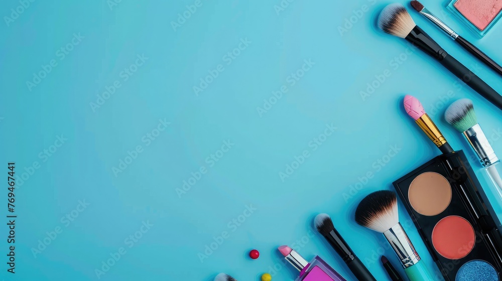 Makeup brushes and cosmetics on blue background. Flat lay, top view. Makeup brushes and cosmetics on blue background. Flat lay, top view.