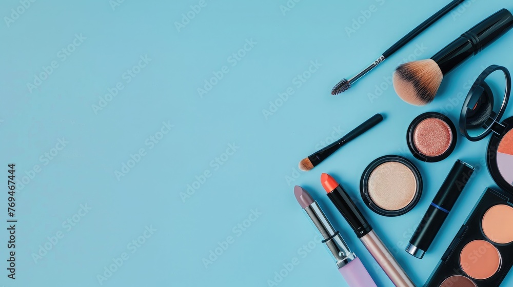 Makeup brushes and cosmetics on blue background. Flat lay, top view. Makeup brushes and cosmetics on blue background. Flat lay, top view.