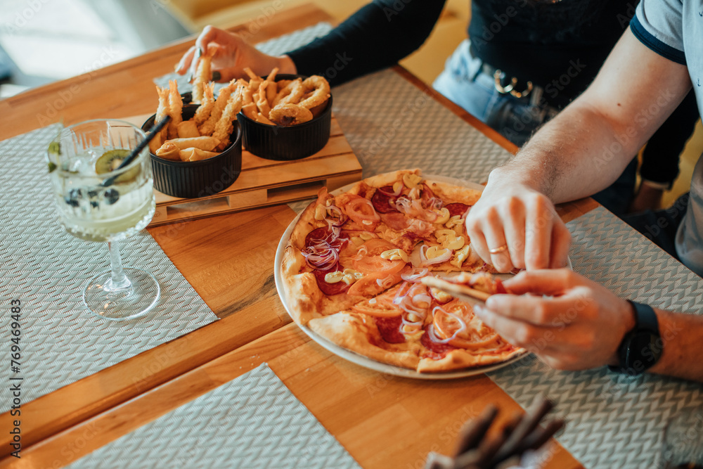 pizza and dipping menu eating process with hand by romantic couple in family restaurant