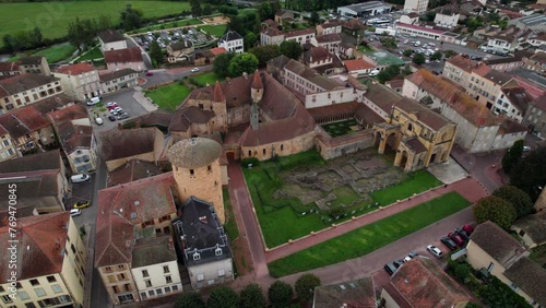 aerial shot over Charlieu Benedictine abbey and Saint Fortunatus priory in Loire department near Roanne on an overcast day, important cluniac site in Auvergne Rhone Alpes region, France photo