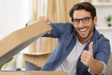happy hipster man wearing glasses showing thumb up