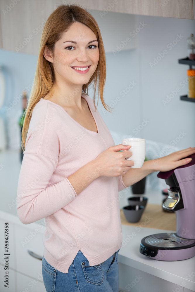 young woman making coffee in coffee machine young woman making coffee in coffee machine