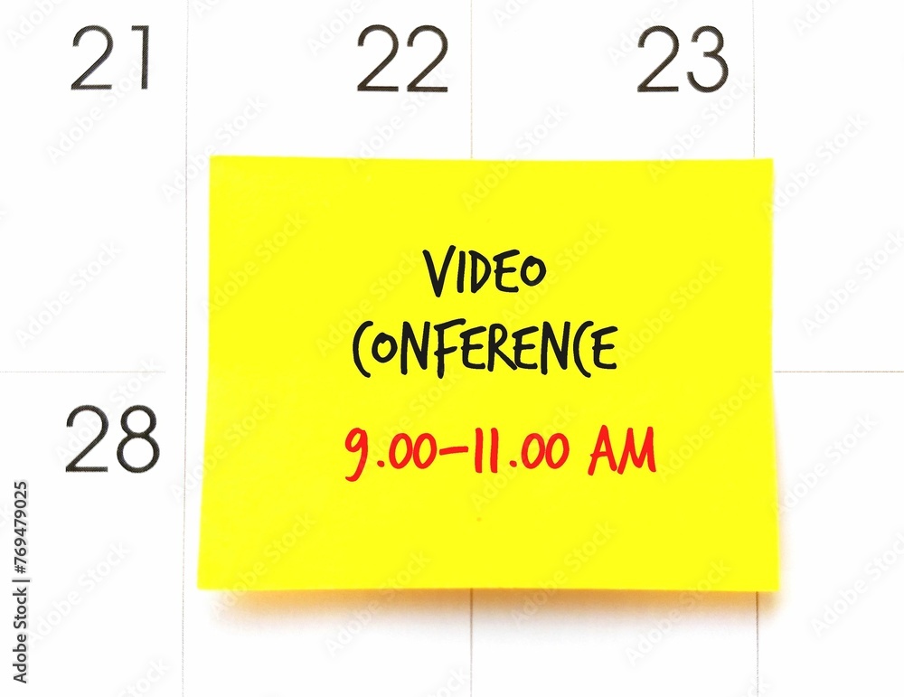 Yellow stick note on date calendar planner with text written Video Conference 9.00-11.00 am, new normal work from home, remote meeting conducted in platform multiple participants can join through mob Yellow stick note on date calendar planner with text written Video Conference 9.00-11.00 am, new normal work from home, remote meeting conducted in platform multiple participants can join through mob