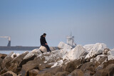 Boy Sitting on the Rocks Admiring the Open Sea, Contemplative Solitude