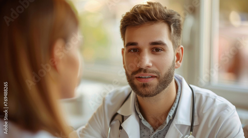 Male doctor talking with female patient in hospital. Healthcare and medical service.