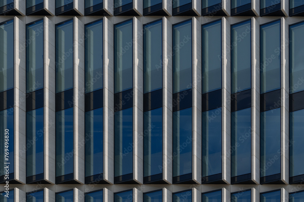 Detail of the facade of modern office building with high windows. Detail of the facade of modern office building with high windows.