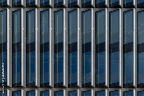 Detail of the facade of modern office building with high windows.