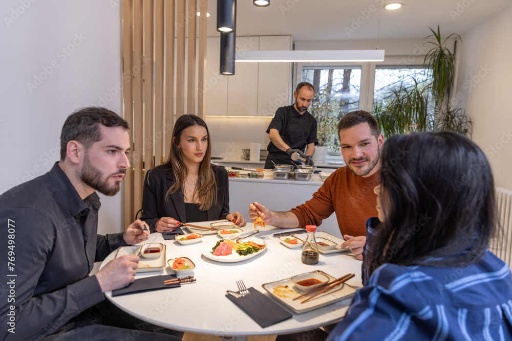 Group of people having diner with private chef at home