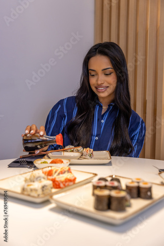 Beautiful Brazilian woman eating sushi