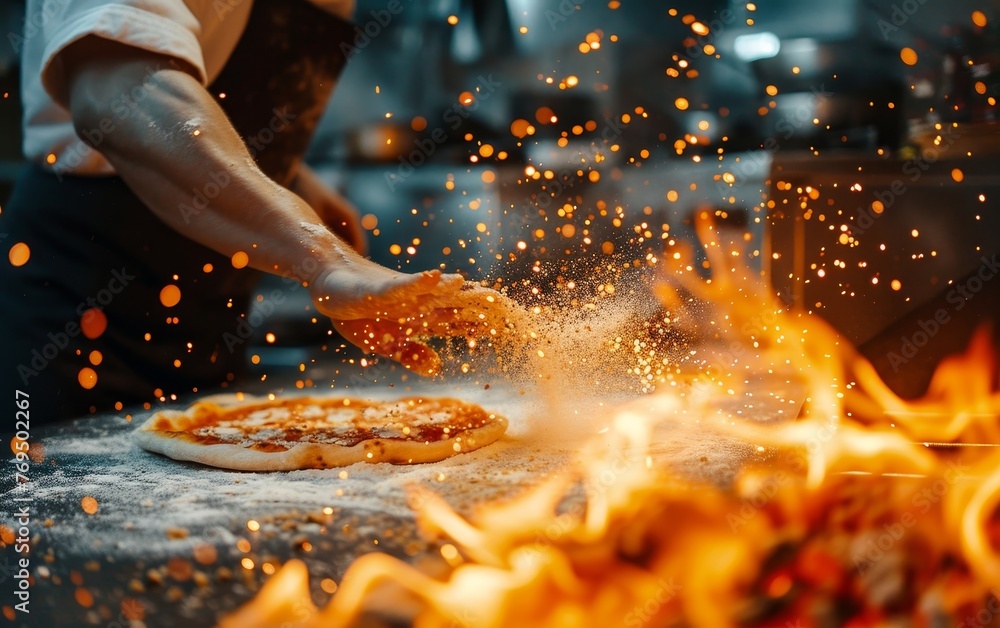 Cook adding a handful of flour to pizza on a fiery kitchen backdrop. - obrazy, fototapety, plakaty 