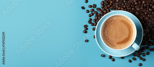 A circle of coffee beans surrounds a ceramic cup filled with a cortado on a blue tableware background, showcasing the main ingredient of this delicious drink