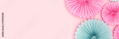 Banner with tissue paper fans in a blue and pink colors. Festive creative composition.