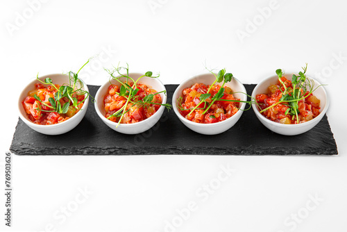 Salmon buffet appetizer, tartare on a white plate. Banquet festive dishes. Gourmet restaurant menu. White background.