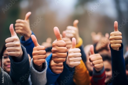 Hands showing thumbs up. Closeup of corporate professionals hand gesturing in the positive or affirmative. photo