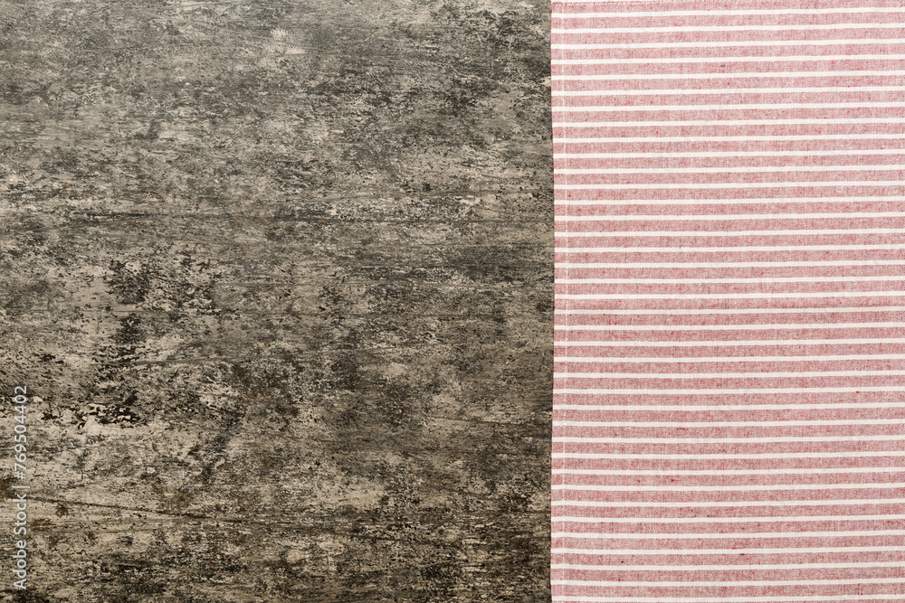 Fototapeta premium top view with red empty kitchen napkin isolated on table background. Folded cloth for mockup with copy space, Flat lay. Minimal style