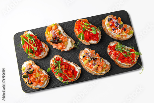 Bruschettas with salmon and tomato. Banquet festive dishes. Gourmet restaurant menu. White background.