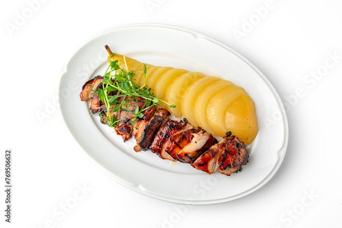 Grilled chicken fillet with baked pear on a white plate. Banquet festive dishes. Gourmet restaurant menu. White background.