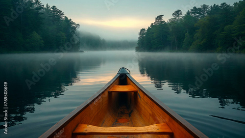 Canoe bow on a misty lake with forest backdrop, serene and tranquil morning. © Creative Clicks