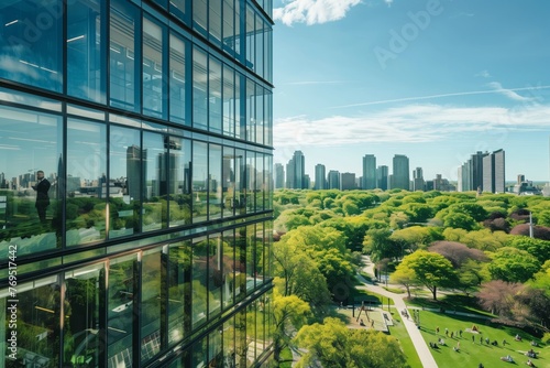 highrise glass office with an individual overlooking a vibrant city park