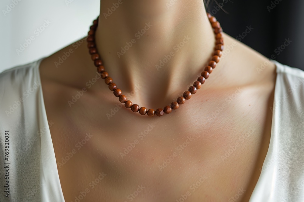 woman wearing a necklace made of sandalwood beads