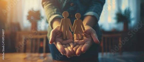 A family is protected by a pair of hands; it represents life insurance