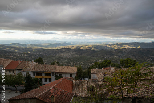 A sunset in a town at the foot of a mountain photo