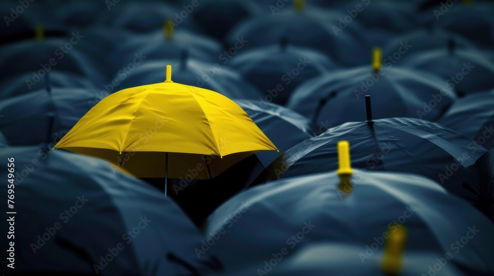 A captivating image featuring a unique yellow umbrella standing out among many dark ones - obrazy, fototapety, plakaty 