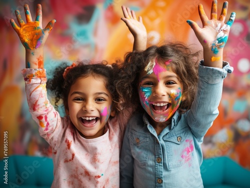 Joyful kids with paintcovered hands up  colorful room  eyelevel capture