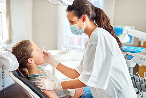 Tools, dentist and woman with child for exam, healthcare or orthodontics for teeth in clinic. Dental hygiene, kid and doctor with mask for patient, oral or cleaning mouth with medical pediatrician photo