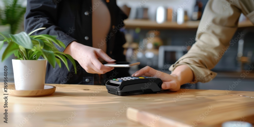 A person making a contactless payment with a smartphone. 