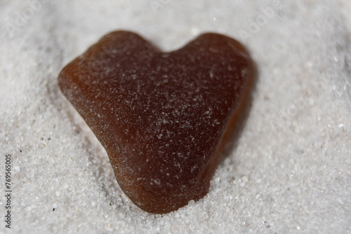 Brown Heart Shaped Sea Glass on a Beach