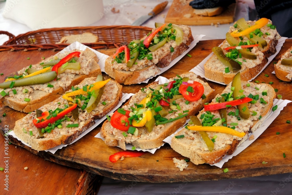 Sandwiches made of home-made bread with lard, cucumber, chives and peppers at a stall during a fair in polish countryside Sandwiches made of home-made bread with lard, cucumber, chives and peppers at a stall during a fair in polish countryside