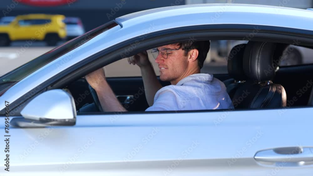Happy guy in glasses enjoying his car trip while singing song and dancing, driving in the city. Transport and lifestyle concept. Slow motion Happy guy in glasses enjoying his car trip while singing song and dancing, driving in the city. Transport and lifestyle concept. Slow motion