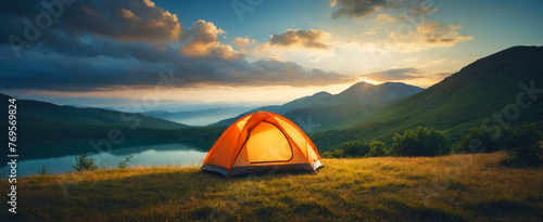 Mountain camping with visible tent, beautiful scenery. Panorama.