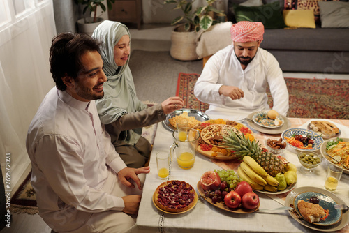 Happy Muslim Family Having Festive Dinner photo